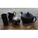 A Wedgwood Jasperware black basalt teapot and milk jug,