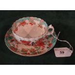 An early 19th century Derby porcelain cup and saucer in the Jabberwocky pattern,