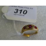 An 18 carat yellow gold ruby and diamond ring.