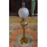 A tall brass Victorian oil lamp on square base (84 cms to include chimney).