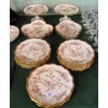 An early 20th century Limoges dessert service, comprising: twelve plates, two tazzas,
