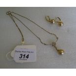 A gold pearl and diamond pendant and earrings en suite,