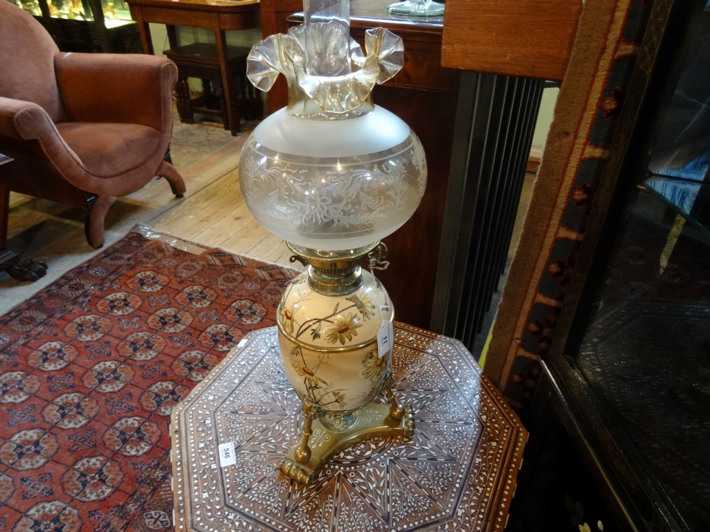 A Victorian oil lamp in the Aesthetic manner,