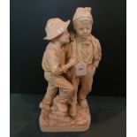 A contemporary resin figure group of two young boys (42cm).