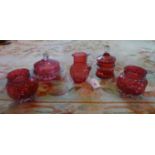 Five pieces of cranberry glass, to include: covered dishes, a pair of vases and a small jug.