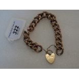 A 9 carat gold curb pattern bracelet and a heart shaped locket, 24 grams.