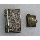 A white metal snuff box, modelled as a book,