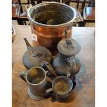 A copper coal bucket, together with a quantity of pewter teapots and other items.