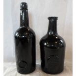 Two early 19th century green glass bottles, each having applied lozenge, one reading J.