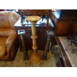 A pair of oak floor standing candle holders,