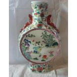 A large 20th century Chinese Famille Vert Moonflask, the central reserves decorated with figures,
