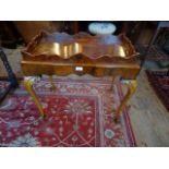 A Victorian walnut tray table on cabriole supports (69cm x 40cm).