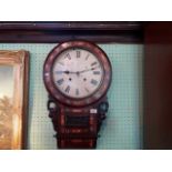 A mahogany and mother of pearl inlaid wall clock, the enamel dial bearing Roman numerals (67cm).