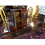 An early 20th century oak wall mounted smoker's cabinet, having five internal drawers,