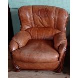 A contemporary tan leather upholstered armchair (85cm wide).