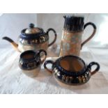 A Royal Doulton stoneware four piece tea set, comprising: teapot, twin handled open sugar bowl,