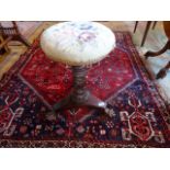 A Victorian mahogany height adjusting upholstered piano stool on triform base.