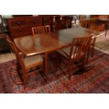 An 1960's extending dining table and four chairs.