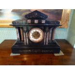 A large Victorian black slate mantle clock, the enamel dial bearing Arabic numerals (41.5cm x 39cm).