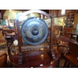 A 20th century Thai mahogany framed gong (80cm tall).