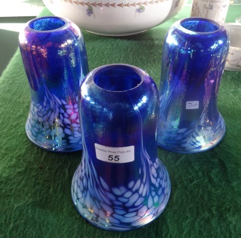 A set of three blue iridescent glass lampshades (16cm).