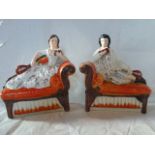 A pair of Staffordshire flatback figurines, depicting a lady and gentleman,