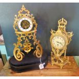 A rococo-style mantle clock on oval base, together with a further ormolu mantle clock.