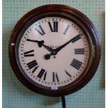 A large 20th century oak cased school clock, the enamel dial bearing Roman numerals (lacking glass),