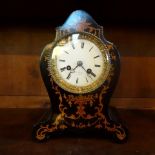 A French mantle clock in an ebonised inlaid case,