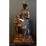 A bronze figure group of a seated Roman lady with a child (36cm).