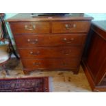 A Georgian oak chest, having two short over three graduated drawers on bracket feet (92cm wide).