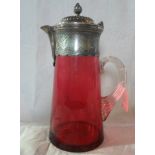 A large Victorian cranberry glass jug with white metal mounts (28cm).