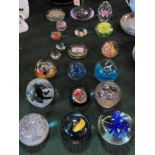 A collection of seventeen glass paperweights, various designs,