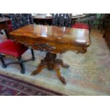 A Victorian rosewood fold-over card table on four out-swept supports (92cm wide).