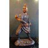 An impressive large bronze figure study of an Oriental Warrior, mounted on an oval base (40cm).