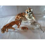 A Beswick figurine of a tiger, together with three other tiger figurines,