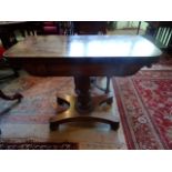 A Victorian mahogany fold-over card table on a reeded and acanthus leaf column,