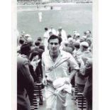 Fred Trueman: 8x10 inch photo signed by the late Freddie Trueman, pictured leaving the field after