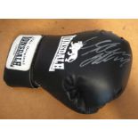 Autographed Boxing glove. Black full size Lonsdale boxing glove with an unidentified boxing