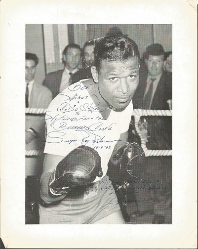 Sugar Ray Robinson 10 x 8 inch b/w photo in the training ring with gloves on. Inscribed and