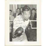 Sugar Ray Robinson 10 x 8 inch b/w photo in the training ring with gloves on. Inscribed and