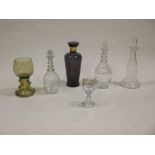 Four various decanters, a roemer and an enamelled glass