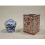A Chinese square section brush pot painted in red together with a blue and white meiping