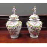 A pair of 'La Courtille' marked flower encrusted jars and covers