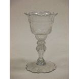 An 18th century sweetmeat glass with faceted cut decoration, 18cm high