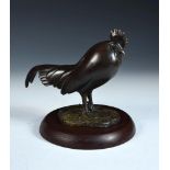 After Francois Pompon, (French, 1855-1933), a patinated bronze model of a cockerel, mounted on a