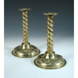 A pair of Arts & Crafts brass candlesticks, each with twist columns, the scones and spreading