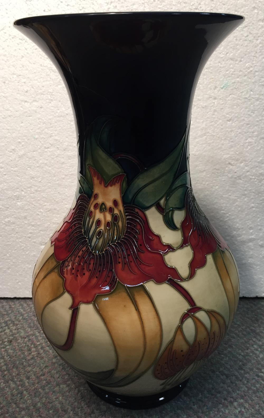 A large Moorcroft Anna Lily pattern vase, the baluster body with flared rim, painted and impressed