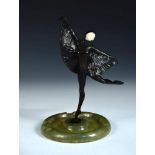 An Art Deco bronze and ivory model of a Bat or Butterfly dancer, she stands upon one leg, arms