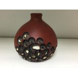 A small Poole stoneware vase by Guy Sydenham, with carved and glazed repeated circular patterns,
